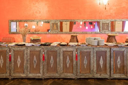a buffet line with plates of food on it at Amareclub Baia Dei Turchi Resort - Adults Only in Otranto