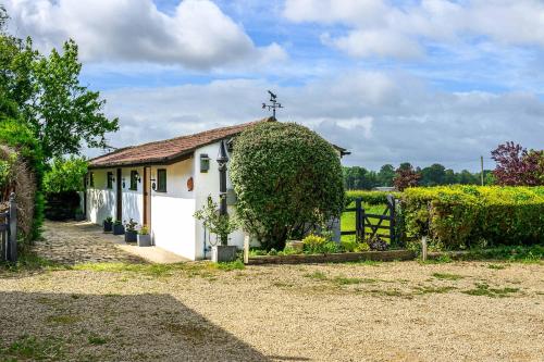 a small white building with a cross on the roof at Rose - Delightful Stables Conversion By STAE-Homes in Bristol