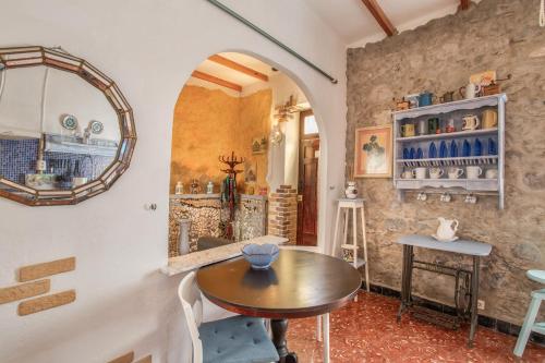 a room with a table and a counter with a mirror at Casa Rustica San Francisco 3 in Telde