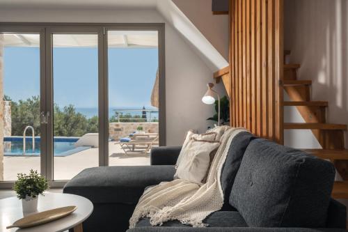 a living room with a couch and a table at Villa Kamaria with Private Pool and Sea View, by ZanteWize in Alykes