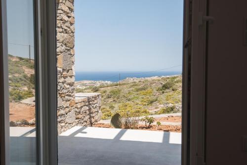 a window view of the ocean from a house at Noble 7 Suites - Adults Only - Onar Hotels Collection in Parikia