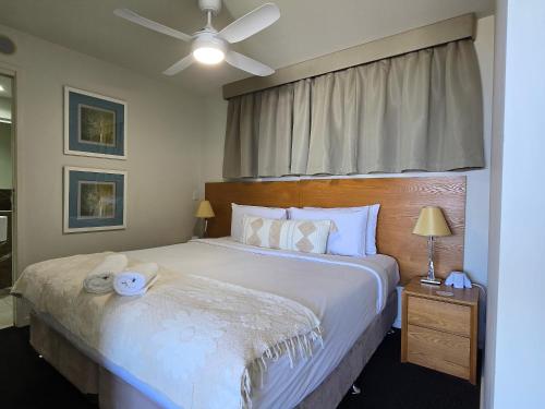 a bedroom with a bed and a ceiling fan at Ocean Retreat in Yeppoon