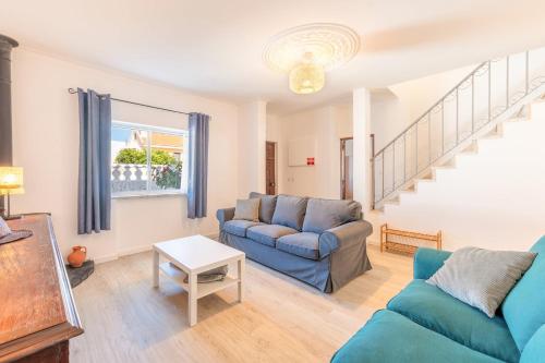 a living room with a couch and a table at GuestReady - Serene Escape Close to Aroeira Beach in Lisbon