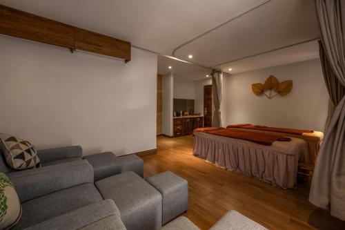 a living room with a couch and a bed at HA Ocean Front Hotel and Apartment in Hoi An