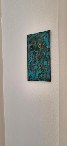 a painting of an octopus on a wall at Lichia Apartment in Pula