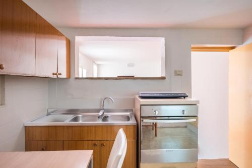 a small kitchen with a sink and a counter at Biancolino Apartments in Nardò