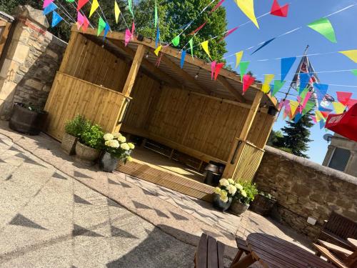 a building with flags and potted plants in front of it at New Crown Inn Bath in Bath