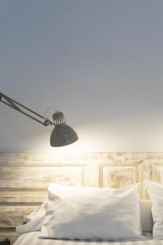 a bedroom with a bed with a lamp on it at La Antigua Fonda in Hervás