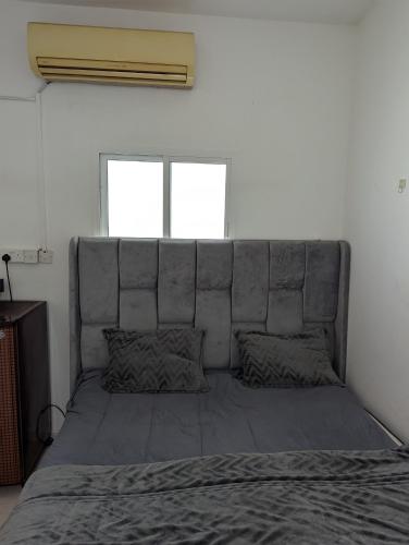 a large bed in a bedroom with a large headboard at Cozy Comfort Studio Central Muscat in Muscat