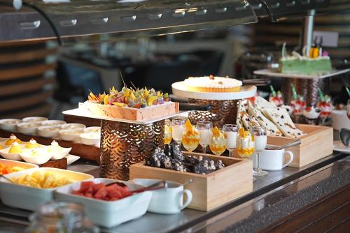 a buffet with cakes and other desserts on display at Le Meridien New Delhi in New Delhi