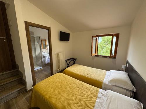 a hotel room with two beds and a mirror at Agriturismo Barbitto in Sezze