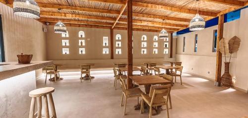 a restaurant with wooden tables and chairs in a room at Cabana Blu Lifestyle Boutique Hotel & Suites in Kardamaina
