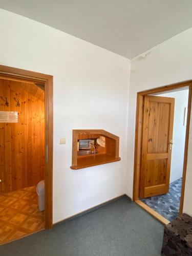 a room with a toilet and a wooden door at Vila Lenka in Pěnčín