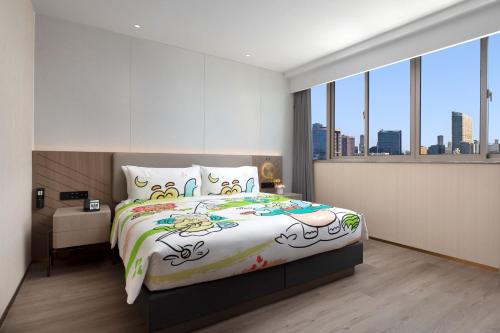 a bedroom with a large bed and a large window at Holiday Inn Shanghai Jing'an in Shanghai