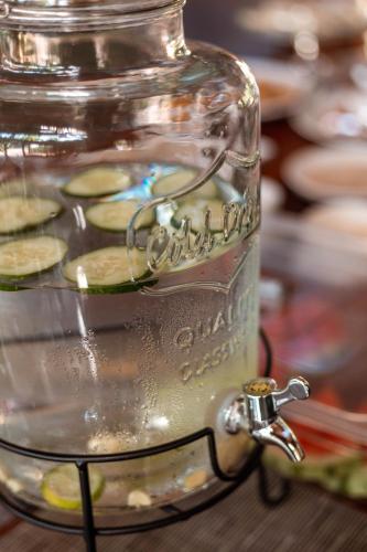 a glass jar filled with food sitting on a table at The Garten Living in Paje