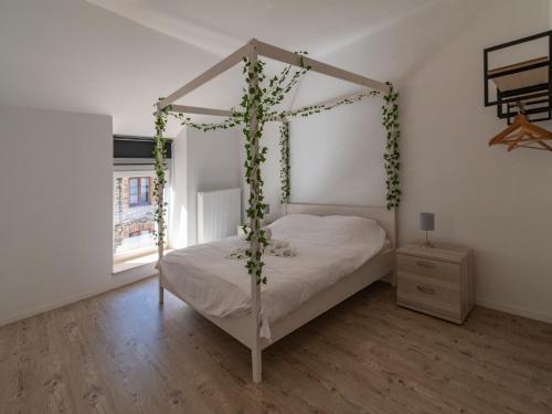 a bedroom with a canopy bed with ivy at Holiday Home in La Roche near Center in La Roche-en-Ardenne