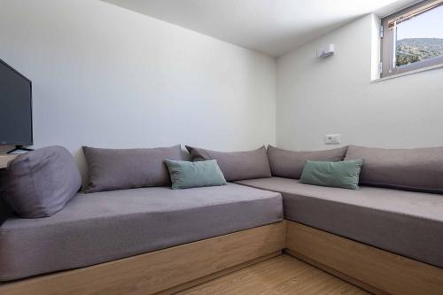 a couch with two pillows sitting in a room at Villa Eva Chania in Neo Chorio