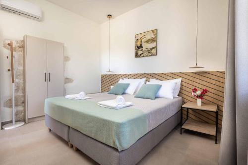 a bedroom with a large bed with two plates on it at Villa Eva Chania in Neo Chorio