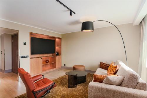 a living room with a couch and a table at Radisson Blu Latvija Conference & Spa Hotel, Riga in Rīga