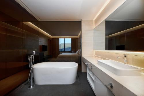 a bathroom with a large tub and two sinks at The Westin Xi'an in Xi'an