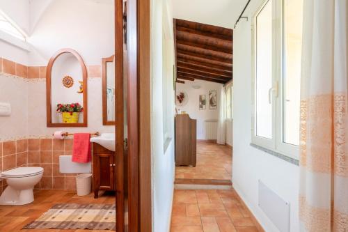 a bathroom with a toilet and a sink at Casa Nespolo in Tortolì