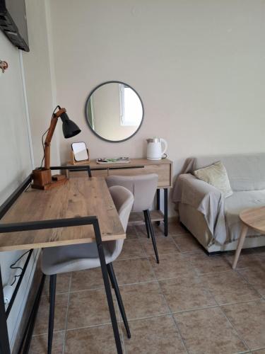 a room with a desk with a mirror and a couch at Nisaki City Vibes in Chios