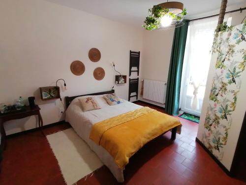 a bedroom with a bed and a large window at Chambre d'hôtes 2 - Exotique - Un Refuge à Cachen in Cachen