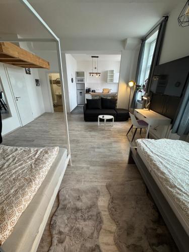 a bedroom with two beds and a living room at Viersen Schöne Apartments am Dülkener Bahnhof Vi01 bis Vi09 in Viersen