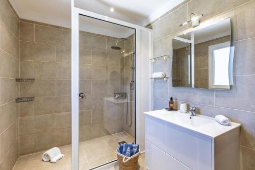a bathroom with a shower and a sink and a mirror at Casa Grande in Jávea