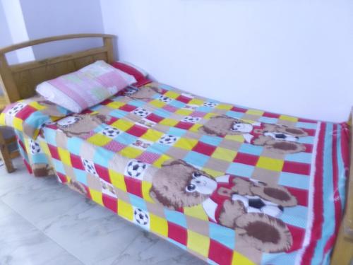 a bed with a blanket with animals on it at برج بيلو بيتش in Alexandria