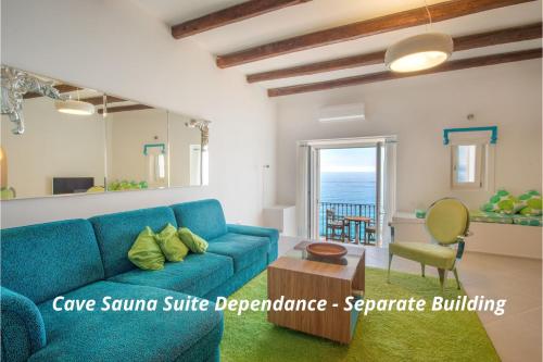a living room with a blue couch and a table at Piccolo Grand Hotel in Pizzo
