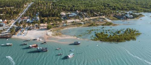 an aerial view of a beach with boats in the water at @Casa.Mauii - Ilha do Guajiru Luxurious House in Itarema