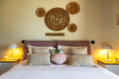 a bedroom with a large bed with pillows and two lamps at Scalma Villas in Skaloma