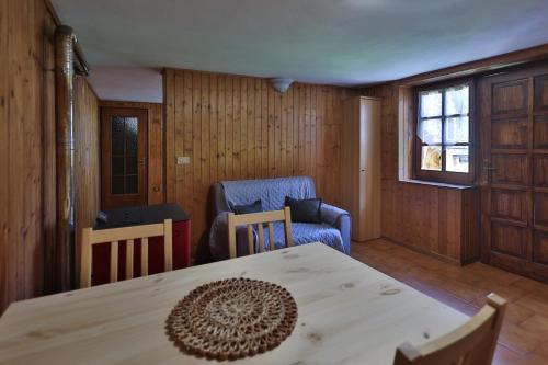 a dining room with a table and chairs and a window at Agriturismo Alberobello in Viganella