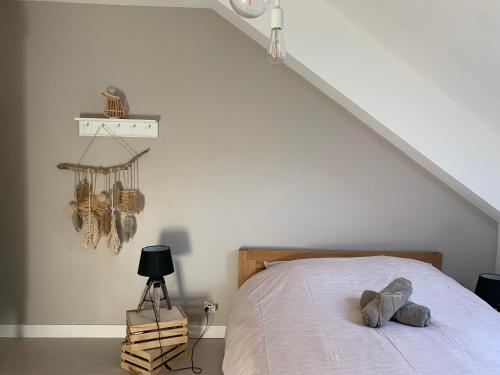 une chambre avec un lit avec un animal en peluche dessus dans l'établissement Maison KERVOYAL DAMGAN 8 personnes, plage à pied, à Damgan