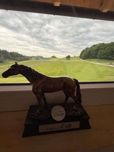 a statue of a horse in front of a window at Cowboy's Land in Višnja Gora