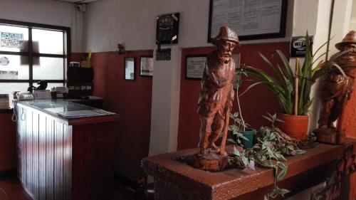 a statue of a man sitting on top of a counter at Hotel Alcayata Popayan in Popayan