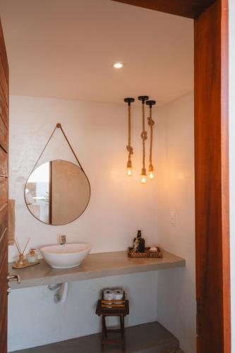 a bathroom with a sink and a mirror at @Casa.Mauii - Ilha do Guajiru Luxurious House in Itarema