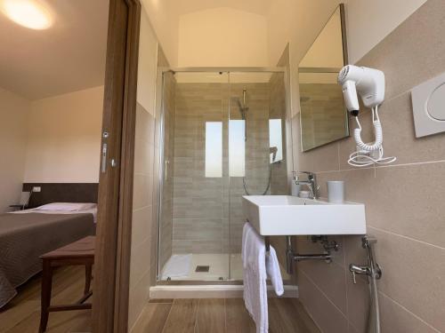 a bathroom with a shower and a sink and a mirror at Agriturismo Barbitto in Sezze