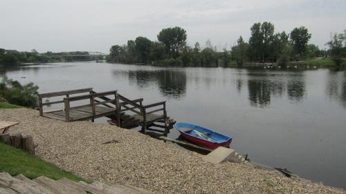 a boat is parked next to a dock on a river at Vila Sunce Morovic in Morović