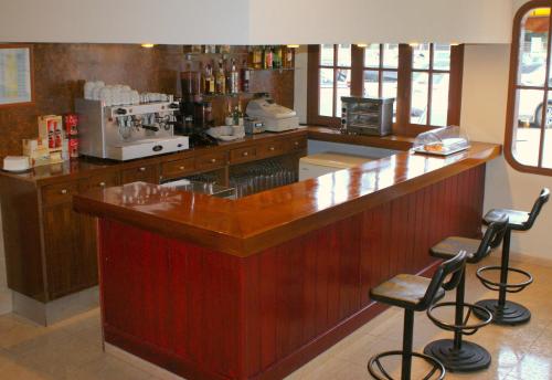 a bar in a coffee shop with two bar stools at Hotel Carabela 2 in Cullera