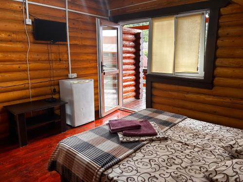 a bedroom with a bed and a tv and a window at Магніт in Solotvyno