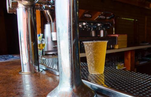 a glass of beer sitting on top of a bar at Магніт in Solotvyno