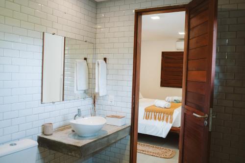 a bathroom with a sink and a bed at @Casa.Mauii - Ilha do Guajiru Luxurious House in Itarema