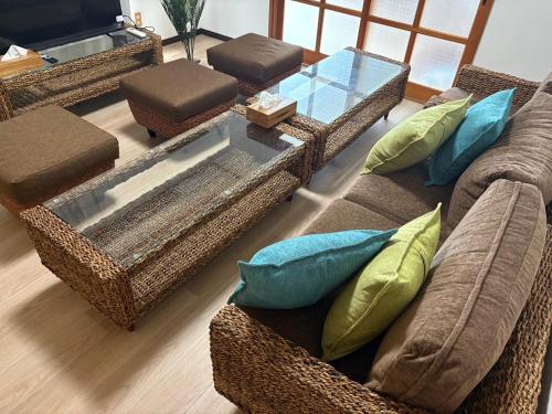 a living room with two couches and a glass table at さぬき Villa 東かがわ in Higashikagawa