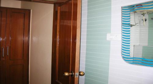 a bathroom with a blue and white striped wall at Athidhi Residency in Tirupati