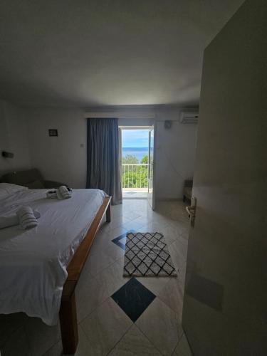 a bedroom with a bed and a door with a window at Apartments Rako in Brela