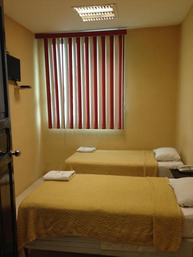 コアツァコアルコスにあるHotel Morenoの窓のある部屋にベッドが2つある