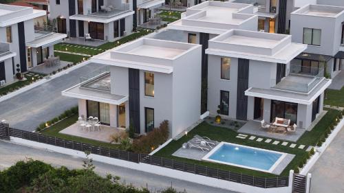 an aerial view of a house with a swimming pool at Nefeli & Nefeli Luxury Residential Complexes in Ofrínion