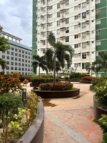 a courtyard with a large building in the background at Avida Towers Riala T2, L&D Stays, Coffee Machine in Cebu City